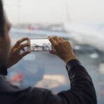man-hand-take-picture-of-airplane-using-cellphone-tourism-concept-photo.jpg